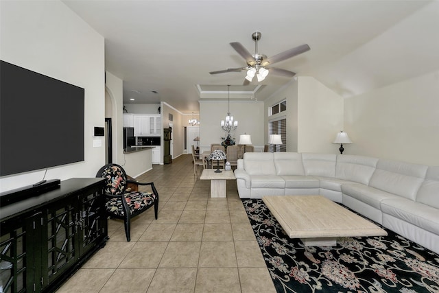 tiled living room featuring ceiling fan with notable chandelier