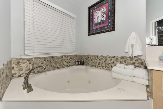 bathroom with a bathing tub and vanity