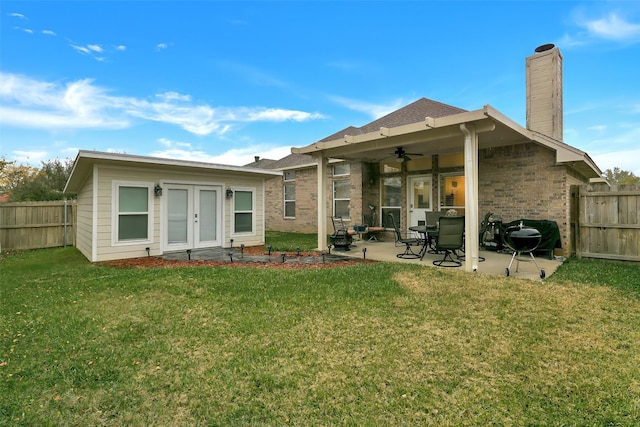 back of house with ceiling fan, a patio area, and a yard