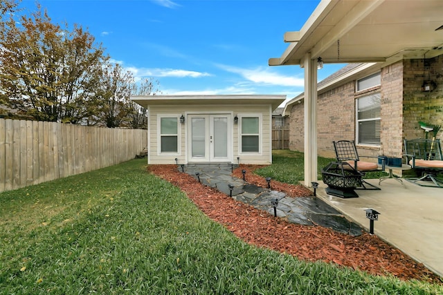 exterior space with french doors, a yard, and a patio area