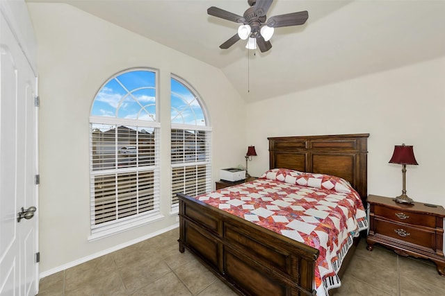 bedroom featuring ceiling fan, light tile patterned flooring, and lofted ceiling