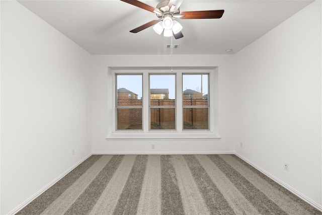 unfurnished room with ceiling fan and carpet floors