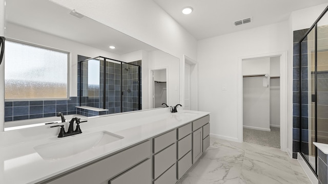 bathroom with a sink, a stall shower, a walk in closet, and visible vents