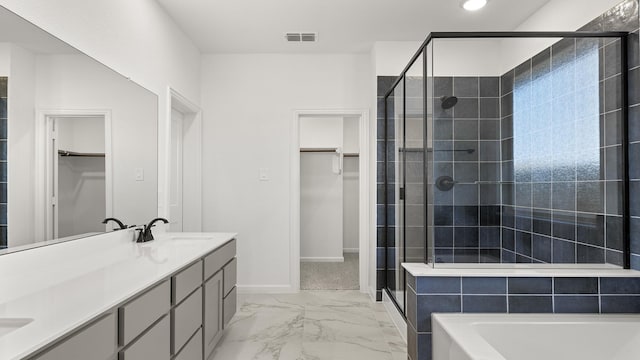 full bathroom with double vanity, visible vents, marble finish floor, a spacious closet, and a sink