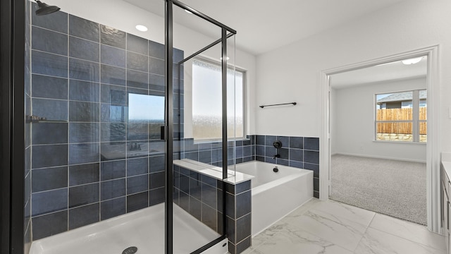 bathroom featuring marble finish floor, a shower stall, vanity, and a bath