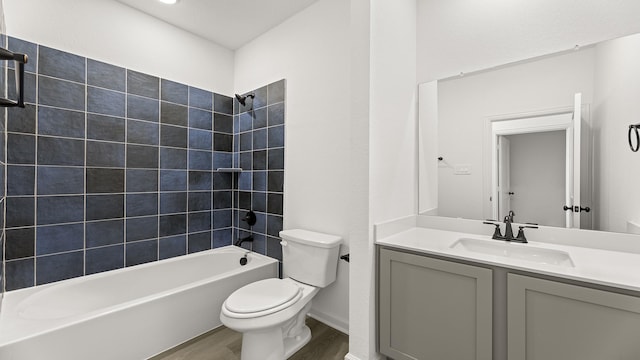 full bath with  shower combination, vanity, toilet, and wood finished floors