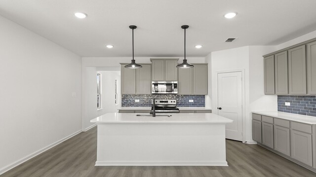 kitchen featuring white cabinetry, light hardwood / wood-style flooring, an island with sink, and stainless steel appliances