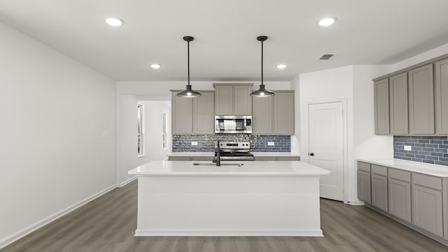 kitchen featuring stainless steel appliances, light countertops, and visible vents