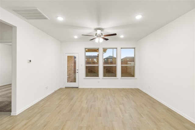 empty room with light wood-type flooring and ceiling fan