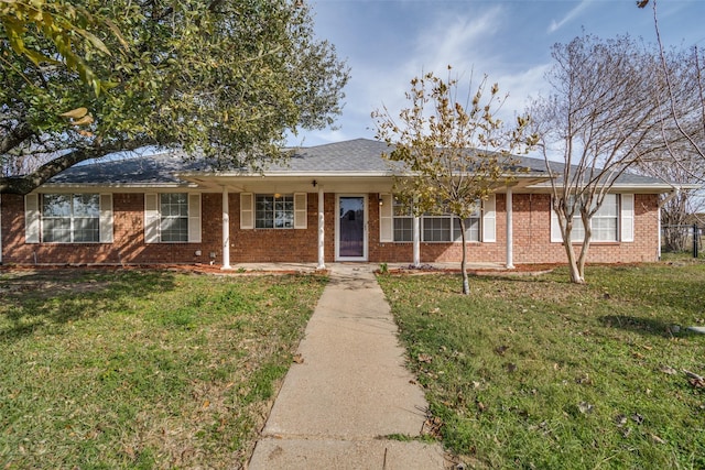 ranch-style home featuring a front yard