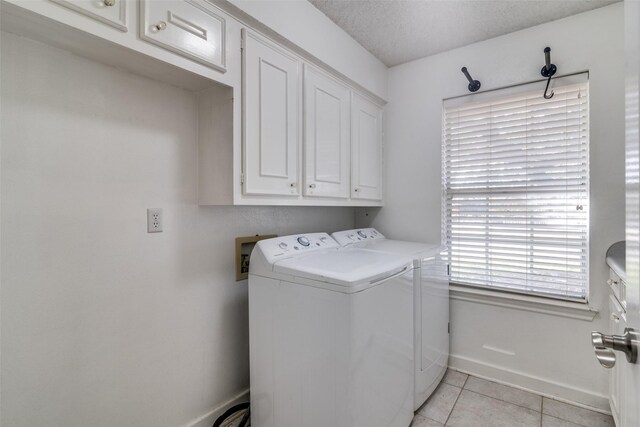 kitchen featuring white cabinetry, sink, light tile patterned floors, and a textured ceiling