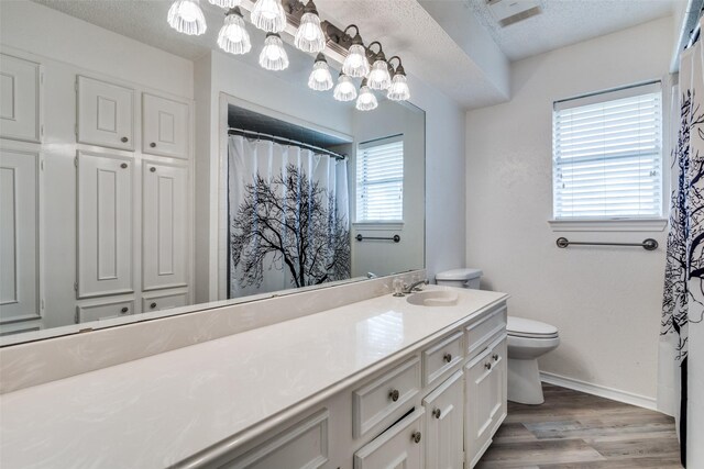 unfurnished room with ceiling fan, light hardwood / wood-style floors, and a textured ceiling