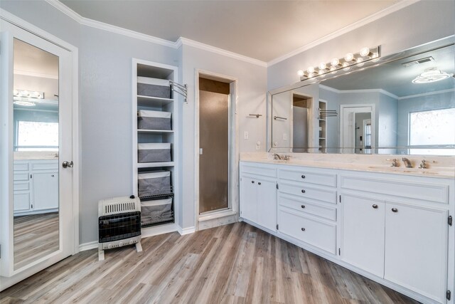 bathroom with ceiling fan, wood-type flooring, toilet, vanity, and ornamental molding