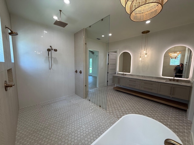 325 Ryker Ln, Gunter, TX 75058 - full bath with a walk in shower, a soaking tub, double vanity, recessed lighting, and a chandelier