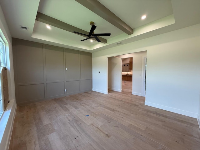 325 Ryker Ln, Gunter, TX 75058 - unfurnished bedroom with a raised ceiling, light wood-style floors, baseboards, recessed lighting, and a decorative wall