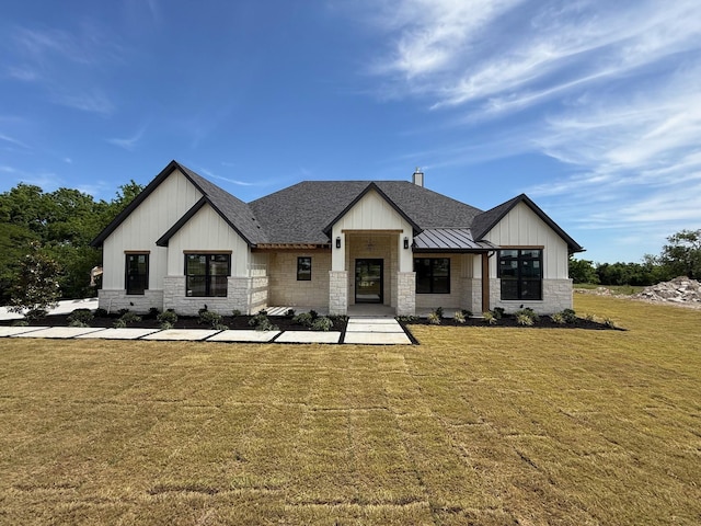 325 Ryker Ln, Gunter, TX 75058 - modern farmhouse style home featuring roof with shingles, stone siding, a front lawn, and board and batten siding