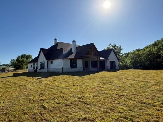 325 Ryker Ln, Gunter, TX 75058 - rear view of house featuring a yard and a chimney