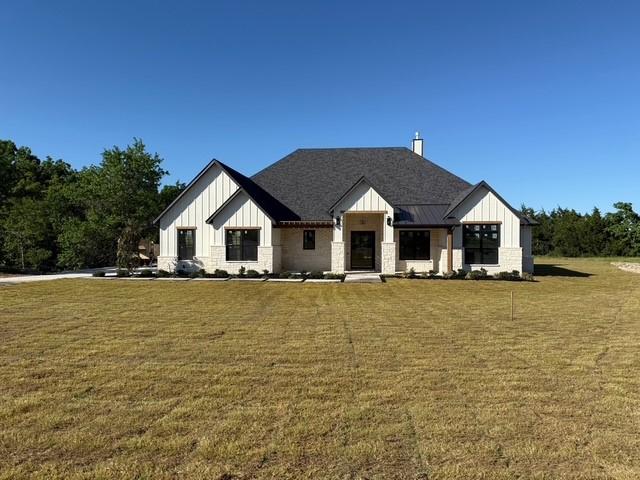 325 Ryker Ln, Gunter, TX 75058 - modern inspired farmhouse with board and batten siding, a front lawn, and stone siding