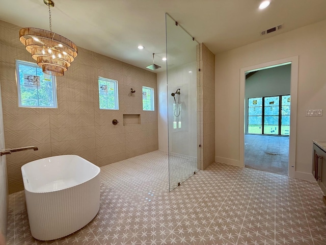 325 Ryker Ln, Gunter, TX 75058 - full bath with a walk in shower, a freestanding bath, tile patterned floors, a chandelier, and recessed lighting