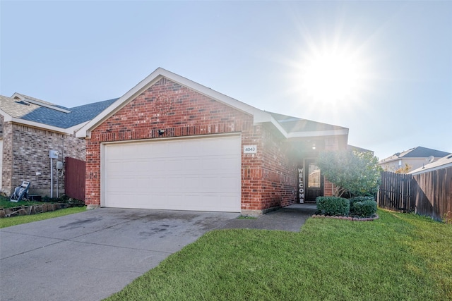 ranch-style home featuring a garage, brick siding, fence, driveway, and a front yard