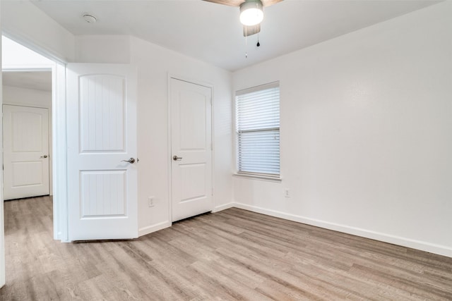 unfurnished bedroom featuring ceiling fan and light wood-type flooring