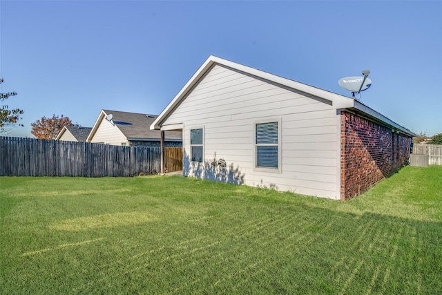 rear view of house featuring a yard