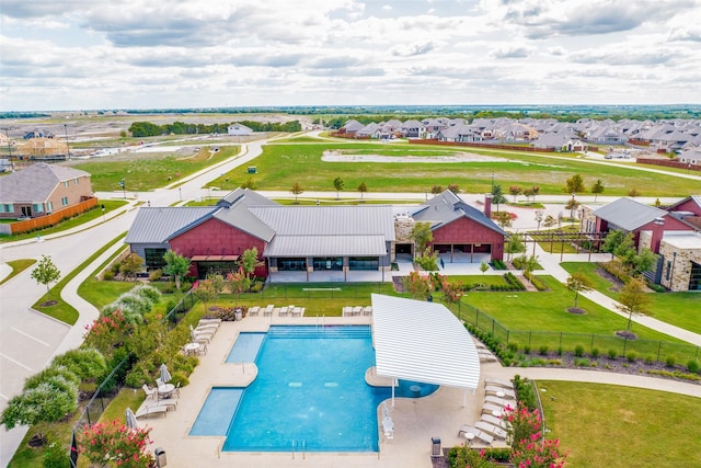 view of swimming pool featuring a residential view and fence