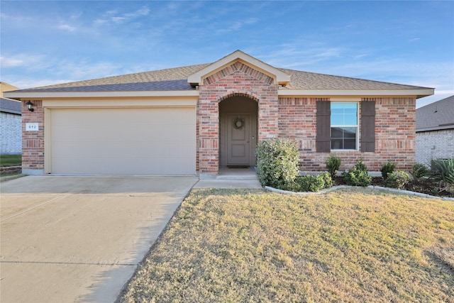 single story home featuring brick siding, a shingled roof, concrete driveway, an attached garage, and a front lawn