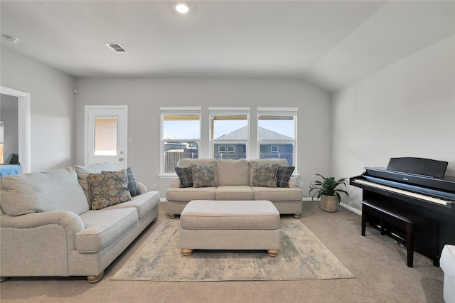 living room featuring light carpet and lofted ceiling