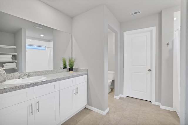 bathroom with a shower with curtain, tile patterned floors, vanity, and toilet