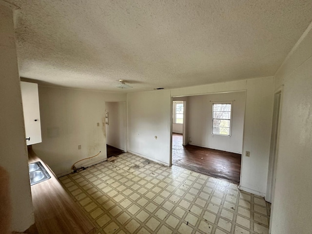 unfurnished room with sink and a textured ceiling