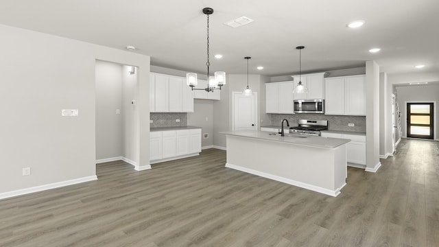 kitchen featuring appliances with stainless steel finishes, backsplash, visible vents, and recessed lighting