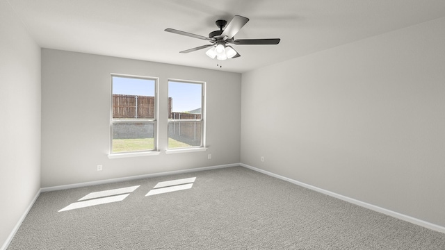 unfurnished room with baseboards, a ceiling fan, and carpet floors