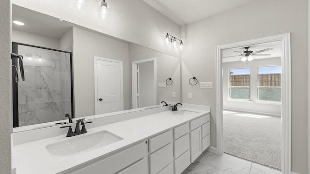 full bath featuring a sink, a marble finish shower, marble finish floor, and a ceiling fan