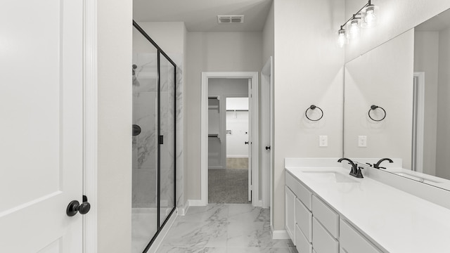 bathroom with a shower stall, vanity, visible vents, marble finish floor, and baseboards