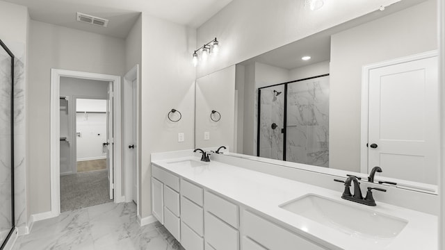 bathroom featuring marble finish floor, a sink, and a marble finish shower