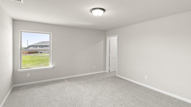 carpeted spare room with baseboards
