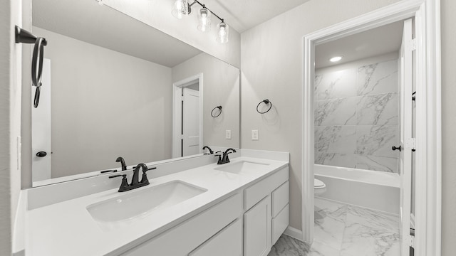 bathroom with a sink, toilet, double vanity, and marble finish floor