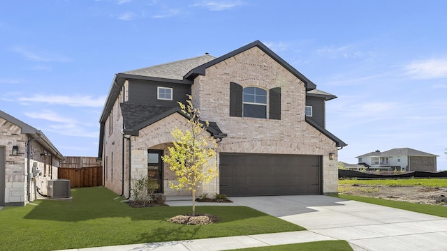 view of front of home with a garage, a front yard, brick siding, concrete driveway, and central AC unit