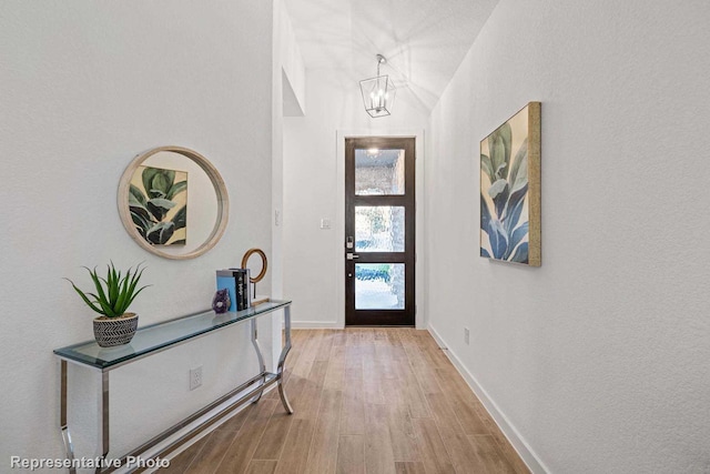 foyer featuring a chandelier and light wood-type flooring