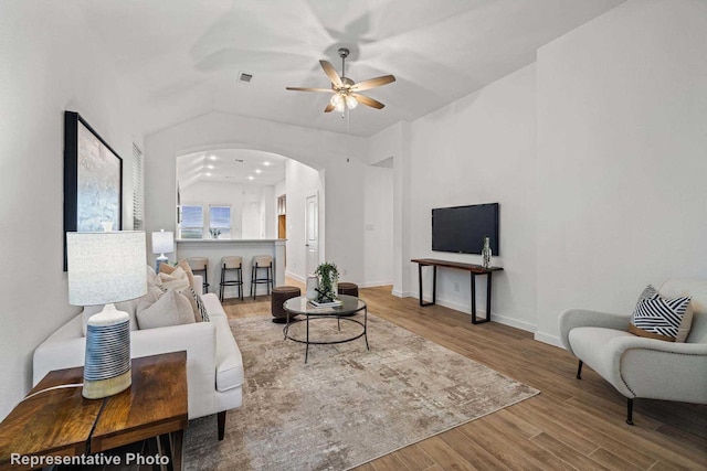 living room featuring wood-type flooring and ceiling fan