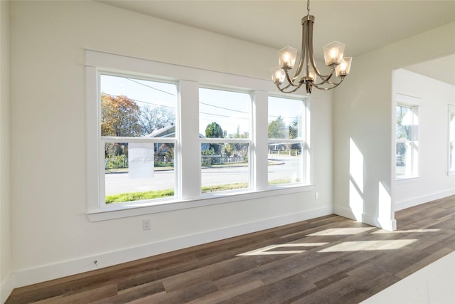 unfurnished dining area featuring dark hardwood / wood-style floors and a wealth of natural light