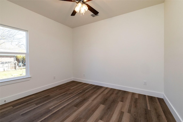 unfurnished room with ceiling fan, plenty of natural light, and dark wood-type flooring