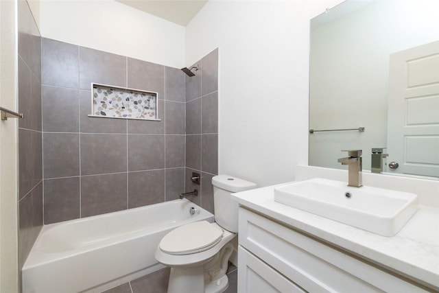 full bathroom featuring tile patterned floors, vanity, tiled shower / bath combo, and toilet