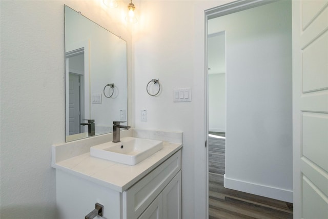 bathroom with hardwood / wood-style floors and vanity