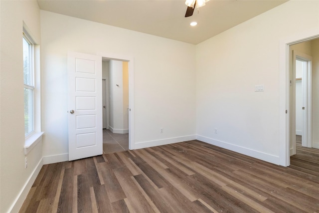 unfurnished bedroom featuring ceiling fan and dark hardwood / wood-style flooring