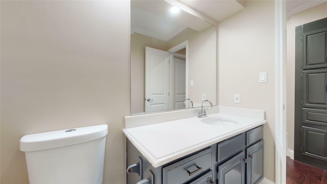 bathroom with vanity, hardwood / wood-style flooring, and toilet