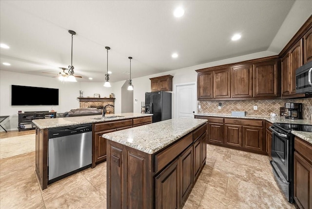 kitchen with black appliances, sink, hanging light fixtures, ceiling fan, and a kitchen island