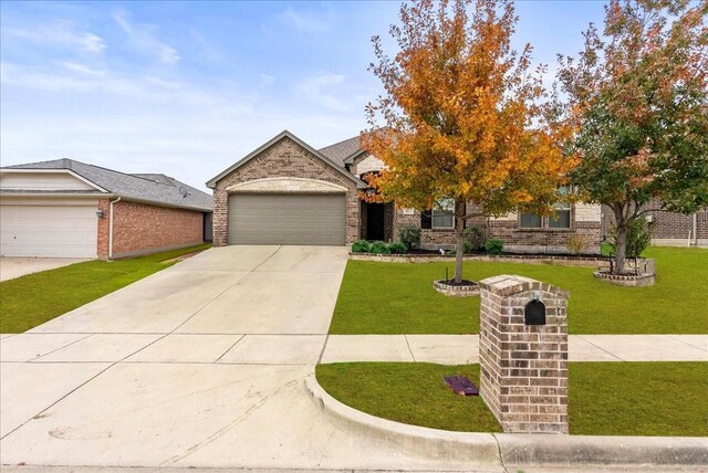 view of front of property with a garage and a front lawn