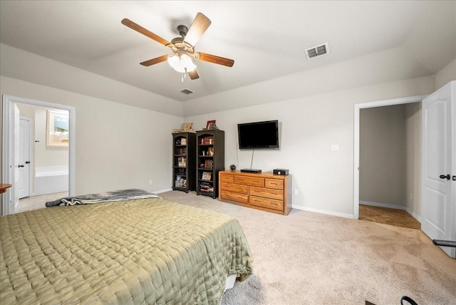 carpeted bedroom with ensuite bath and ceiling fan